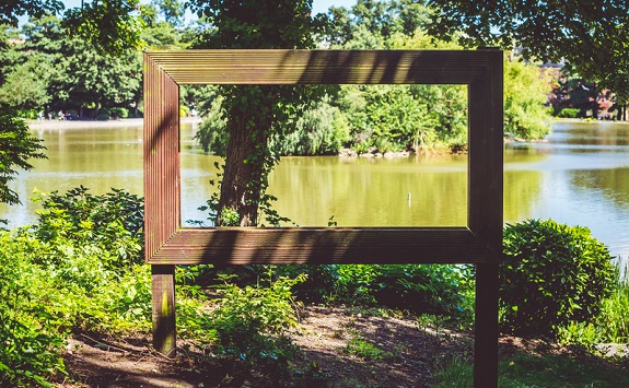 Wooden picture frame in the countryside framing a picturesque view